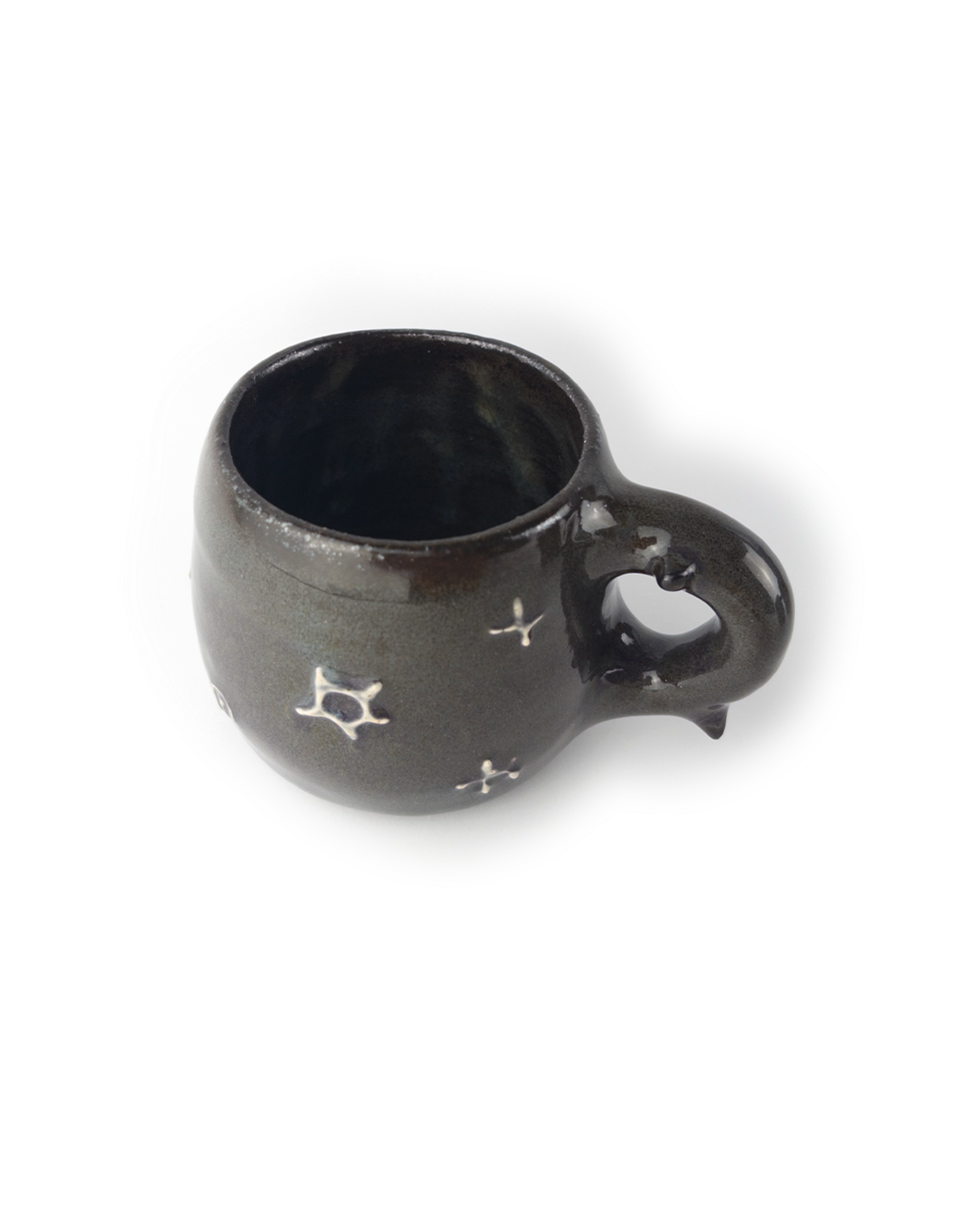 Black ceramic mug with star designs