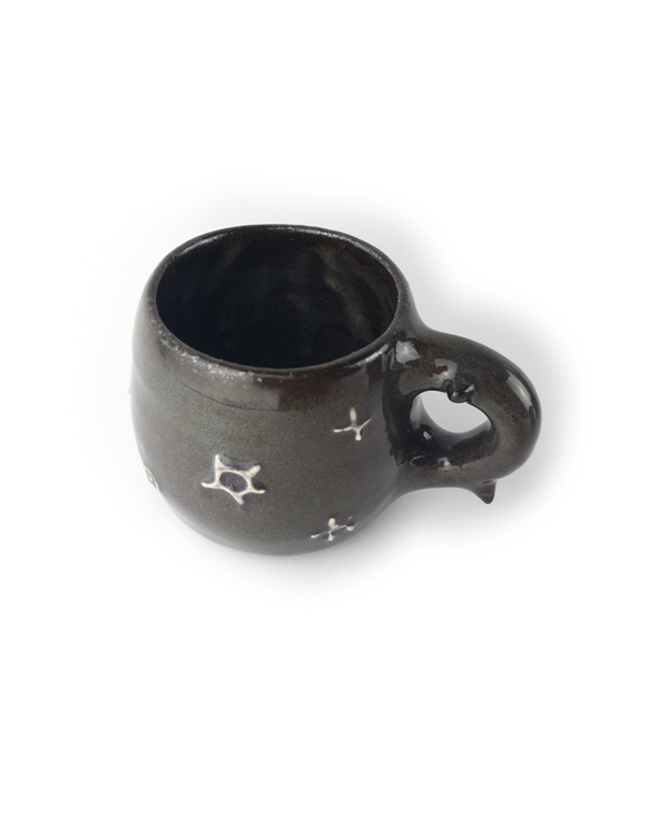 Black ceramic mug with star designs