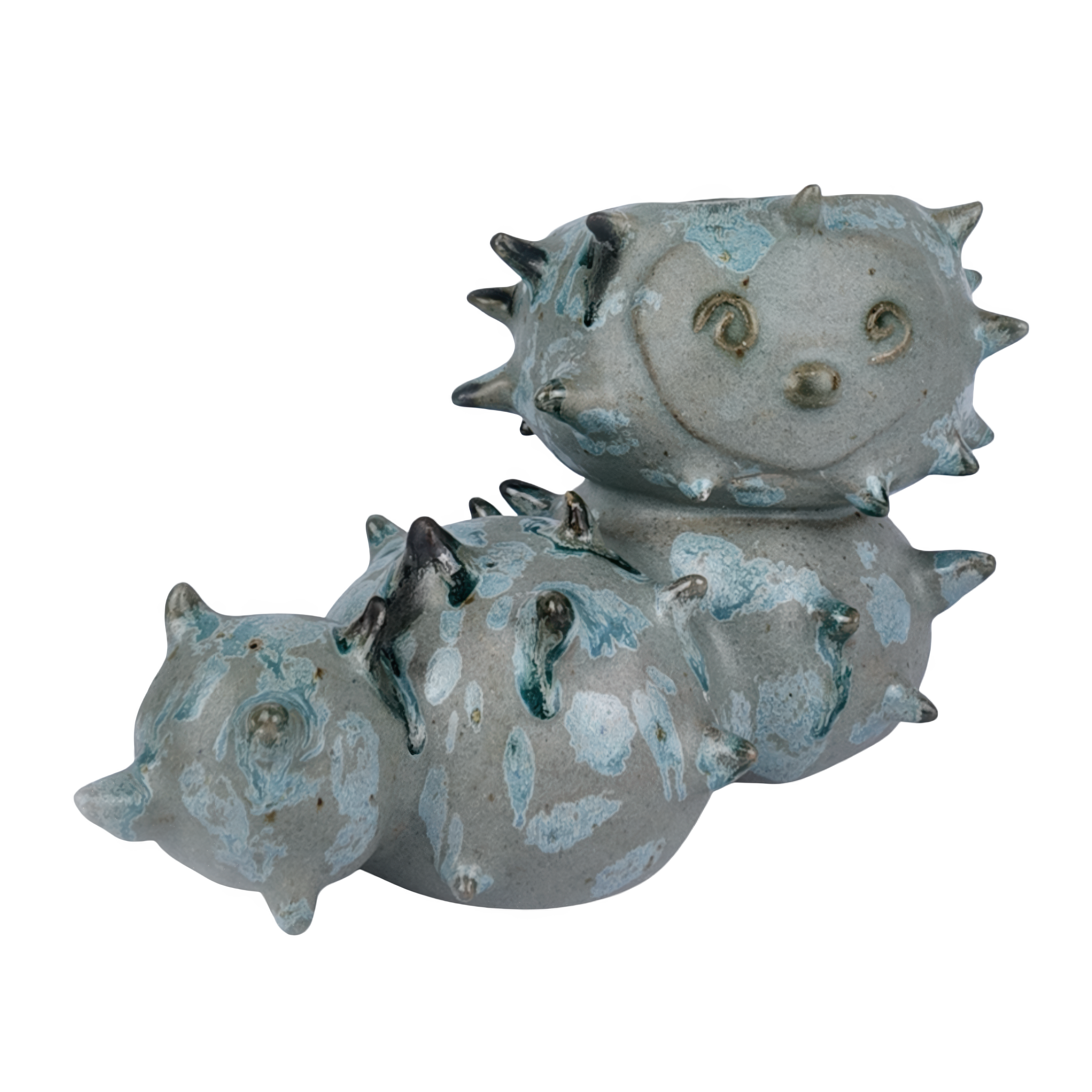 Ceramic sculpture of a sea caterpillar with a textured surface on a white background